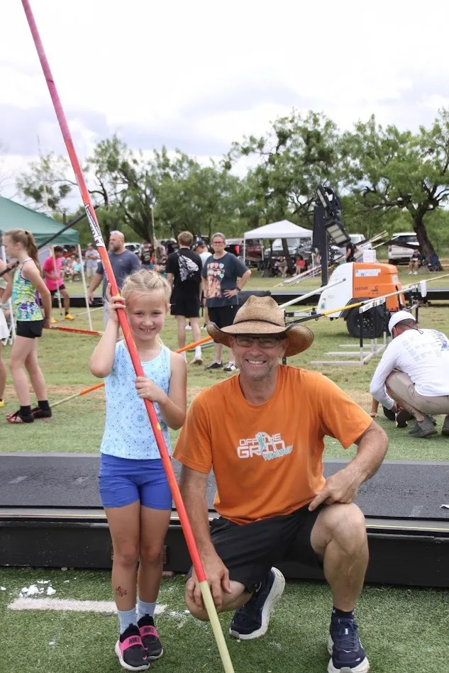 Coach Scotty Miller with a young vaulter at an Off The Grid meet