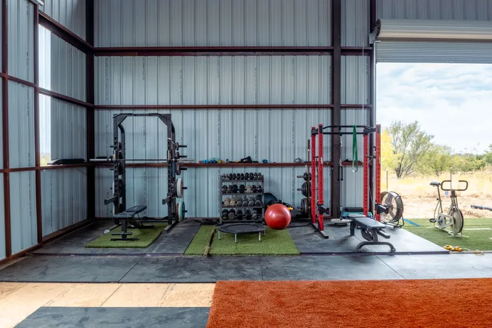 Strength area with racks, dumbbells, and conditioning equipment